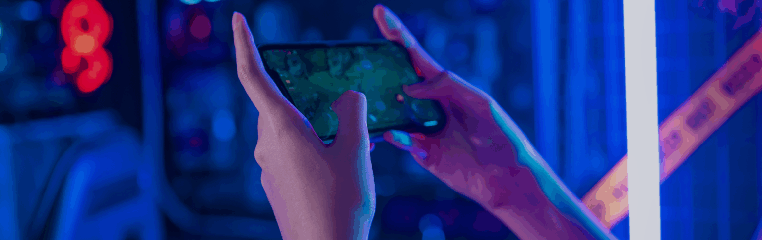 person playing video games on mobile